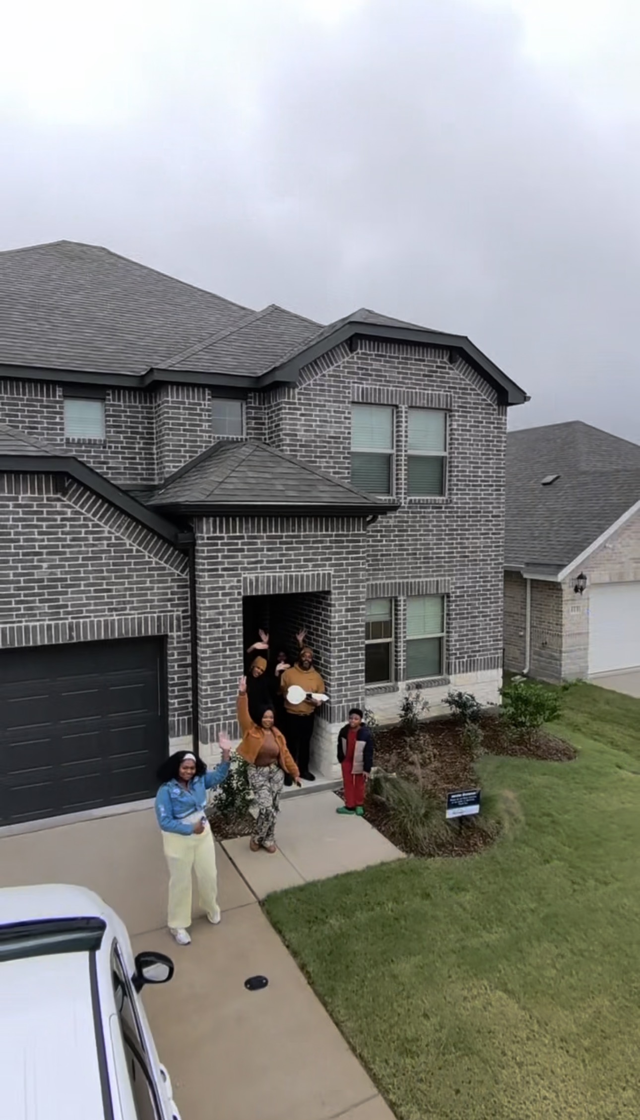 Client with key in front of her new home