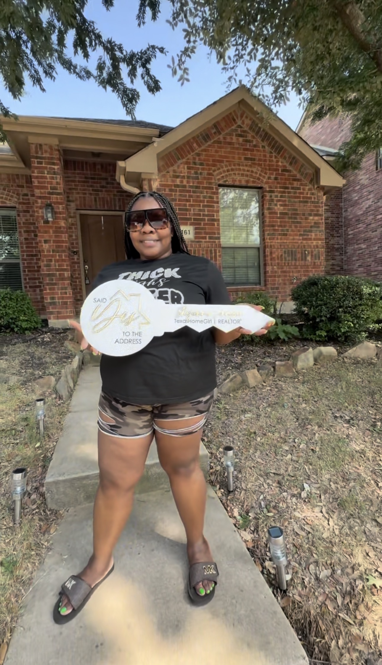 Client holding key sign at new home